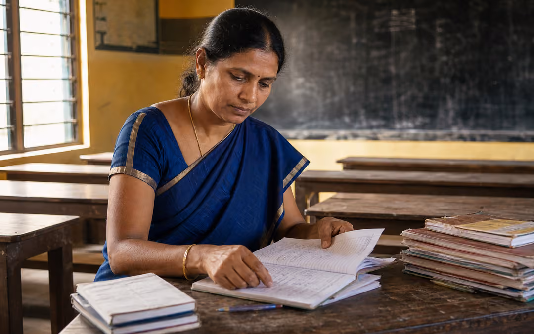 A teacher leader reviewing school plans in a quiet classroom